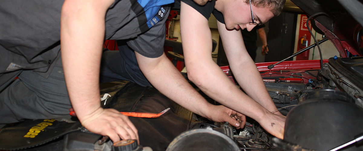 Students fixing car