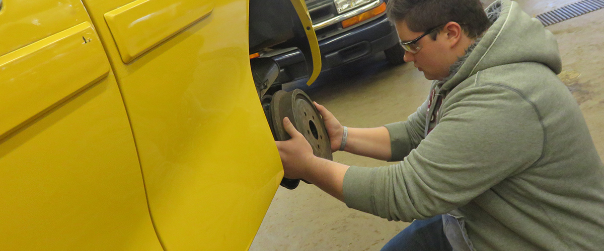 Student doing wheel repairs
