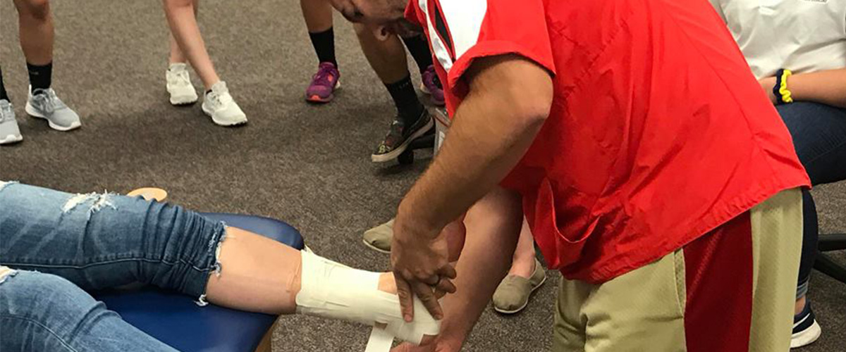 Student getting ankle wrapped